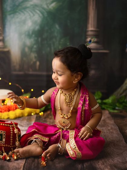 A quiet, candid moment during our Little Krishna photoshoot. He looks so peaceful and sweet sitting amongst the flowers and props.
