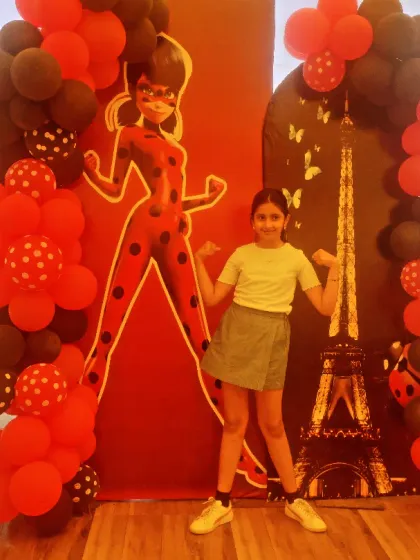 A Miraculous Ladybug themed party for a 9th birthday. The decor features the iconic character against a Paris backdrop with the Eiffel Tower.