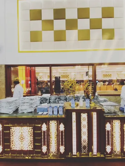 A wide view of one of our large-scale event setups, with staff ready to serve. We ensure every counter is well-organized and fully stocked before the guests arrive.