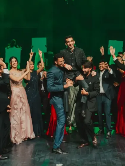 Nothing brings a sangeet alive like friends and family taking the stage. This photo captures the pure, chaotic energy of the groom's crew celebrating together after a performance.