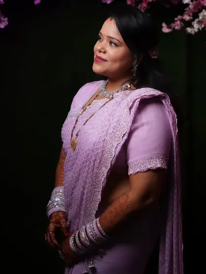 Another angle of the wedding guest, showing her elegant side profile and hairstyle.