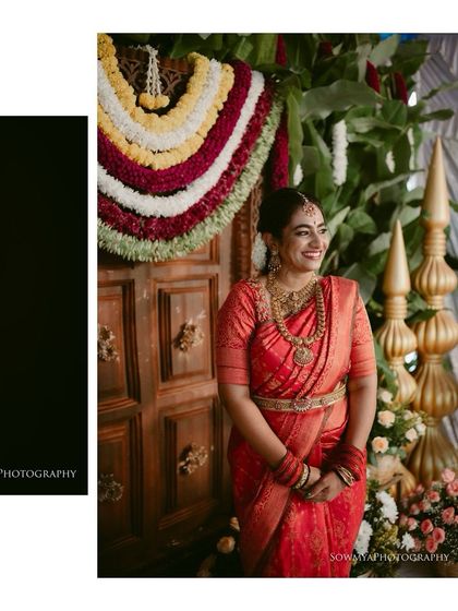 A lovely bride in a red saree, posing in front of a traditionally decorated doorway. Her happy smile lights up the frame.