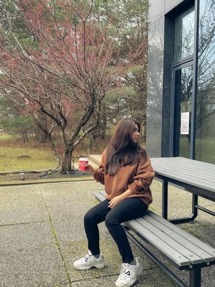 A relaxed moment on a campus bench, celebrating the end of exams. This captures an authentic slice of student life.