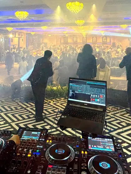 The view from the DJ console, looking out at a packed dance floor. This is the result of a perfectly planned event with great music, lighting, and energy.