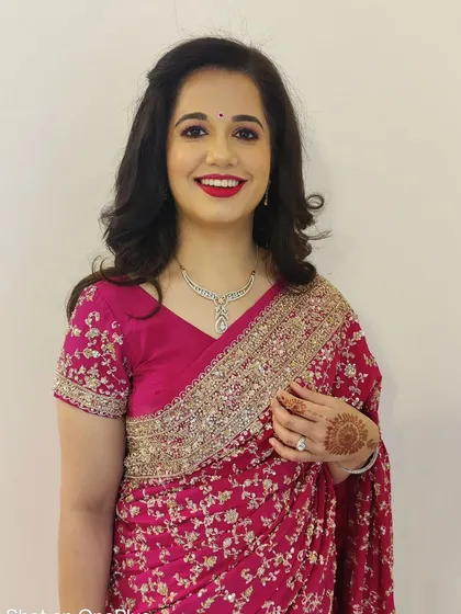 A classic look that never fails. Here, I've styled my client with beautiful, bouncy curls and a timeless red lip for a party. This look is all about elegance and confidence.