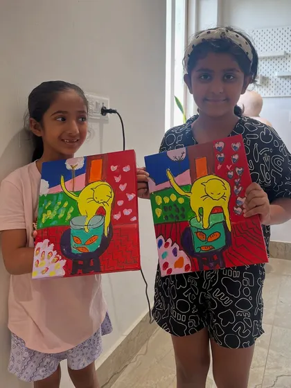 Two friends with their matching cat paintings. It’s fun to see how they interpreted the same subject with their own choice of colors and details.