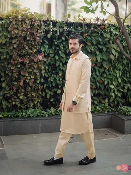 A portrait of the groom, focusing on his sharp, modern sherwani and confident style.