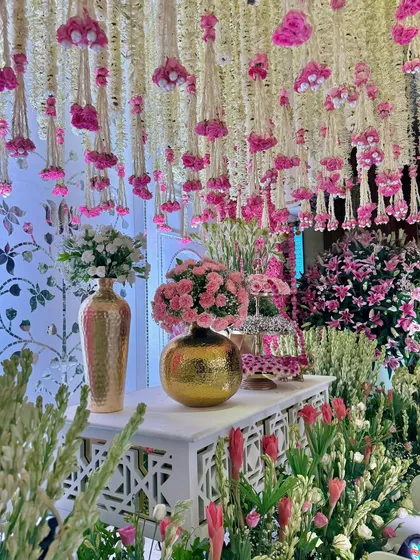 An enchanting bloomscape designed to captivate. We layered draped florals, elegant golden vases, and a symphony of pinks to create a corner filled with pure, celebratory magic.