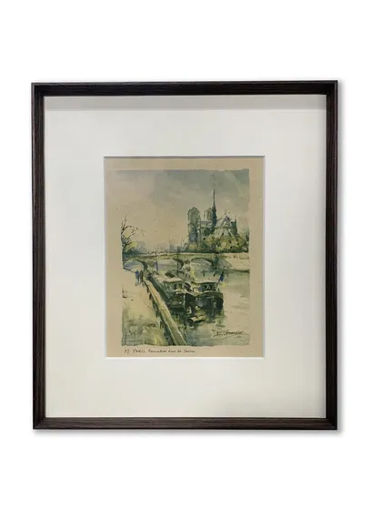 Another example of a vintage Paris print in a dark brown metal frame. The simplicity of the frame allows the artwork's soft colors and delicate lines to be the main focus.