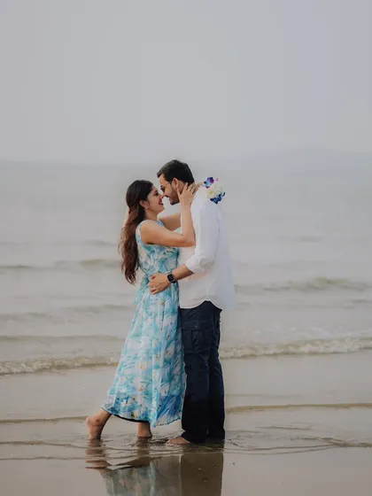 An almost-kiss by the shoreline. This romantic photo captures the anticipation and love between Jayashree and Anand during their beach pre-wedding session.
