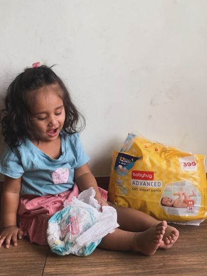 My daughter playing with her Babyhug Advanced diaper. These have been great for preventing leaks and keeping her skin dry, which means fewer changes and a happier baby.