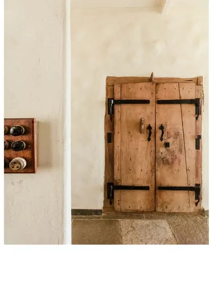 This old door, with its simple iron fittings, was salvaged and given a new home. We believe in curating collections of such pieces that reflect a love for things with history and character.
