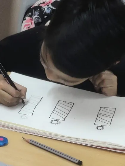 A student practicing drawing basic shapes. Mastering these fundamentals is the first step towards creating more complex artwork.