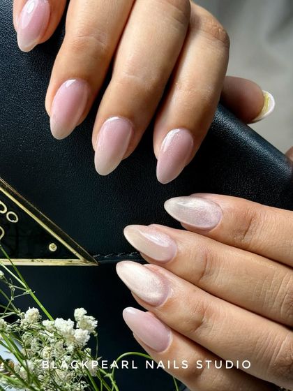 This cat eye glass effect catches the light from every angle, creating a stunning, jewel-like appearance. The picture doesn't do justice to how these nails shine and shift in person, making them truly unforgettable.