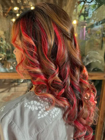 A side view of the 'Peach Delight' hair. The colors are warm and summery, and the curls add beautiful texture.