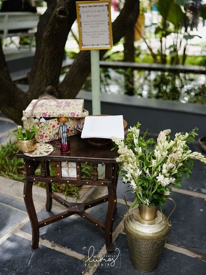 An interactive guest corner with a suggestion box and flowers, designed to engage guests and make them part of the celebration.