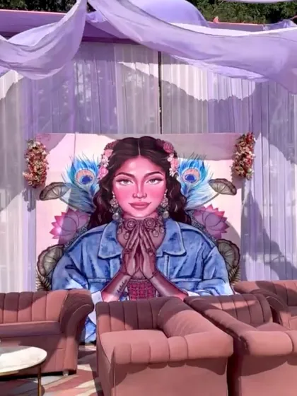 A comfortable and stylish lounge seating area for guests, set against a large, custom-painted backdrop that was a major photo attraction.