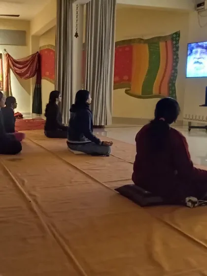 The community watching a discourse by Sadhguru. These moments of learning together are as important as the rituals we perform.