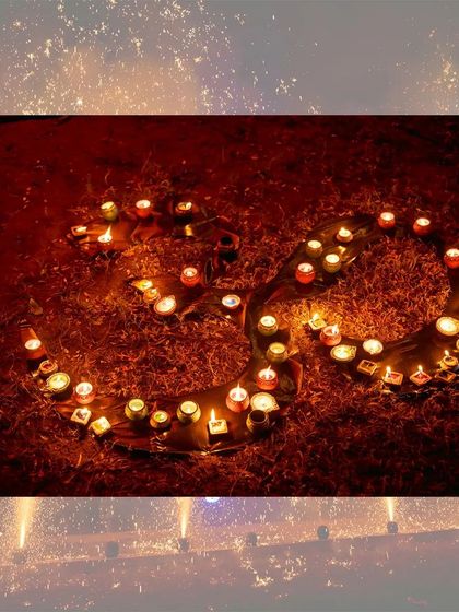An artistic arrangement of diyas forming the 'Om' symbol, a beautiful detail from a Diwali celebration.