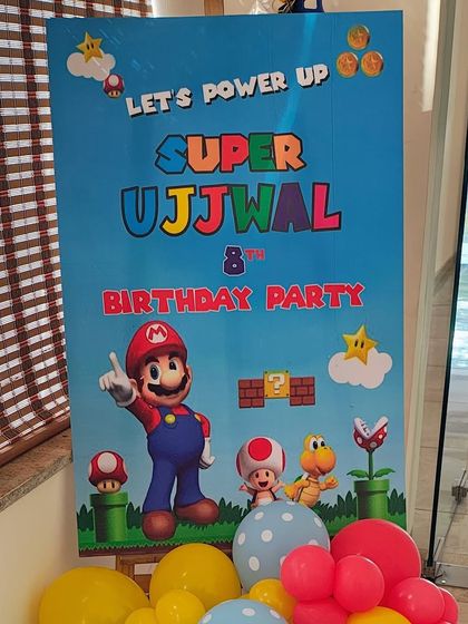 A vibrant welcome sign for a Super Mario themed party, inviting guests to "Power Up".