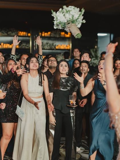 The bride wanted a bouquet toss, but her way. We incorporated this fun tradition into the after-party, creating a moment of laughter and excitement for all her friends.
