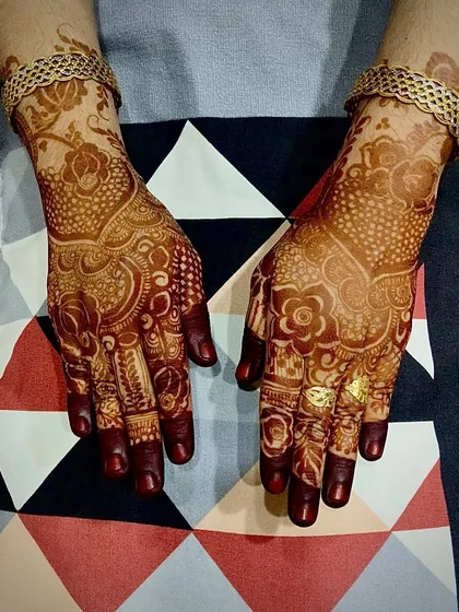 A detailed look at a bridal-style henna stain. The intricate patterns, dots, and floral motifs are all beautifully defined by the rich, dark color.
