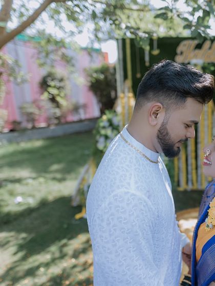 A sweet, candid moment between a couple during their Haldi ceremony, sharing a loving look.