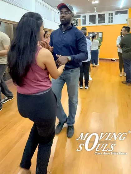 Our classes are a diverse mix of people, all here for the love of dance. Here, students are learning the basic side-to-side step, a fundamental movement in Salsa.