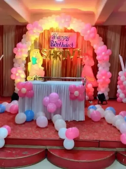 A simple and sweet princess themed decoration for a small stage. It includes a pink and blue balloon arch and pillars with princess cutouts, perfect for intimate celebrations.