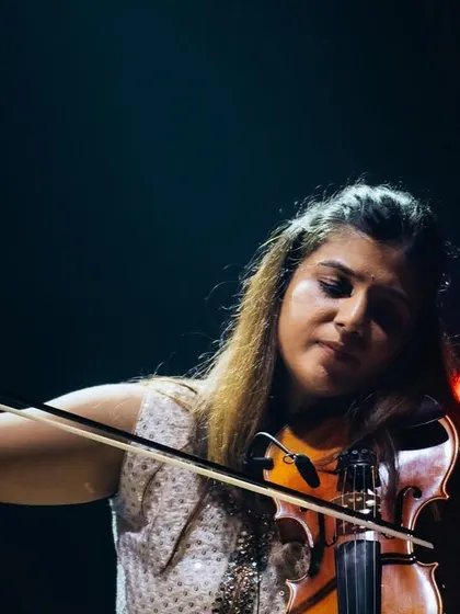 A duplicate of image 124, Apoorva Krishna, completely absorbed in her music during the 'Vari' album release concert. Her solos are always a breathtaking moment in our shows.