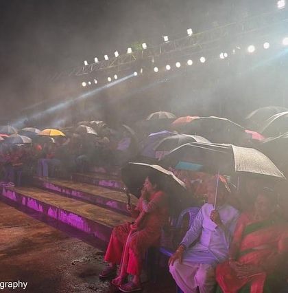 A misty, atmospheric shot of the audience in the rain at the Bengaluru Ganesh Utsava. A night I will never forget.
