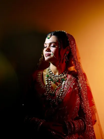 Sneha's bridal portraits are simply breathtaking. The dramatic lighting highlights the soft glam makeup, focusing on her expressive eyes.