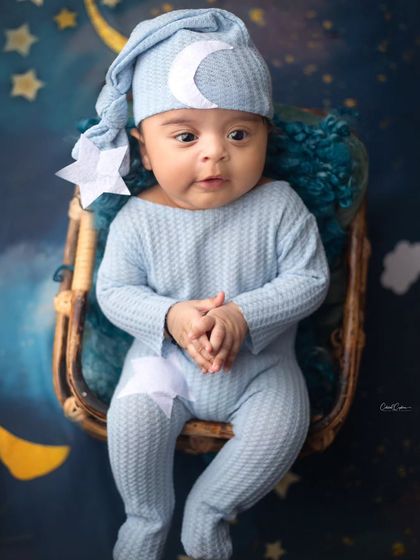 This little one is ready for sleepy time in his moon and stars pajamas. A cute and cozy take on the celestial theme for an awake baby.