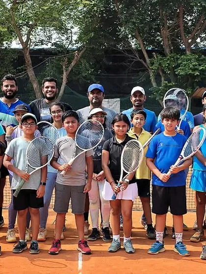 This is the Tennis Vidyalaya family. A group photo of our dedicated players and coaches on the court, ready for another day of hard work. We foster a supportive yet competitive community of athletes who push each other to be their best.