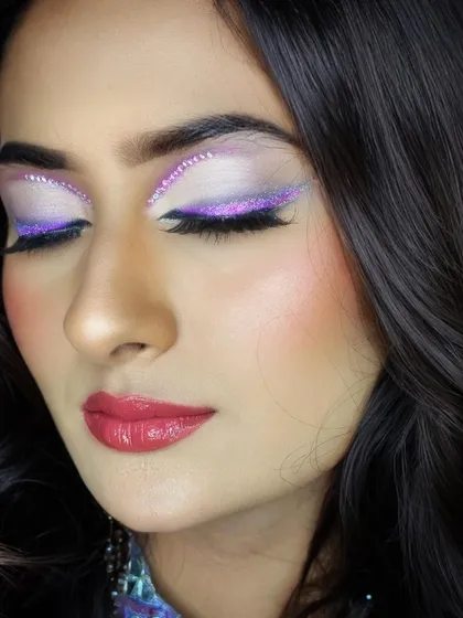 The details make the difference. This close-up shows the intricate glitter work and blending required to create such a stunning and multi-dimensional eye makeup look.