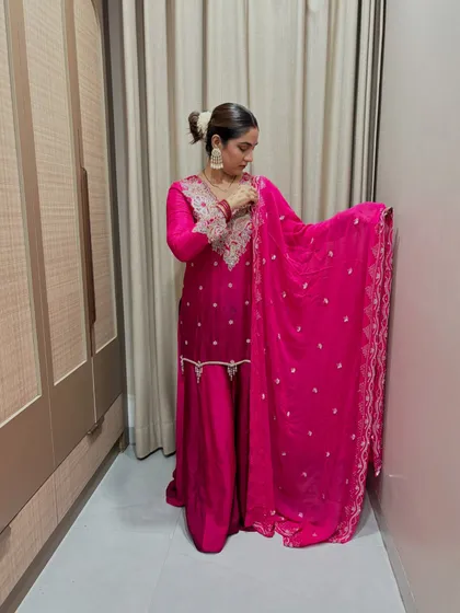 A final look at the pink sharara, showing the full drape of the dupatta. The flowy fabric and rich color make it a true statement piece.