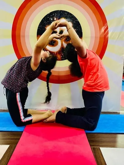 Our young yogis learning the joy of partner poses. This simple backbend helps build trust and teaches them how to support each other in their practice.