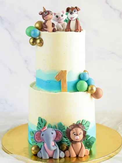 This two-tiered animal-themed cake was for baby Jaee's first birthday. It's so special to be a part of these milestones, creating something memorable for the family.
