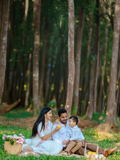 It's the small, shared moments that often mean the most. Here, a mother offers her son a piece of fruit during their picnic, a simple act of care that we preserved as a beautiful, candid memory.