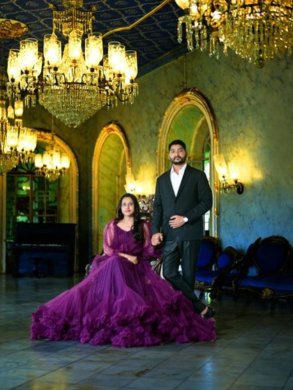 A grand and regal pre-wedding portrait. This couple chose a deep purple gown with voluminous ruffles, which looks stunning in this palace-like setting with crystal chandeliers.
