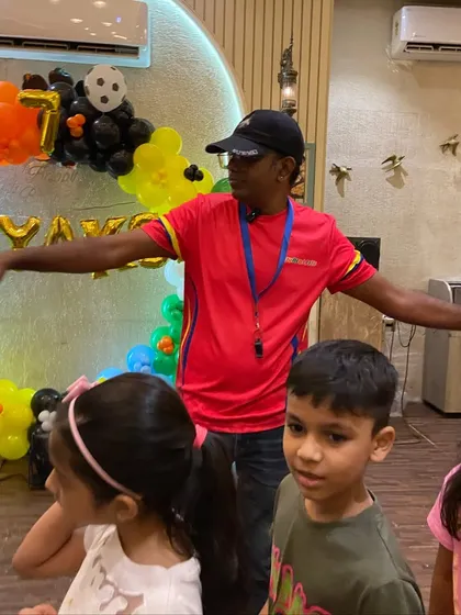 A coach giving directions for the next activity. We ensure our indoor parties are just as organized, safe, and high-energy as our outdoor ones.