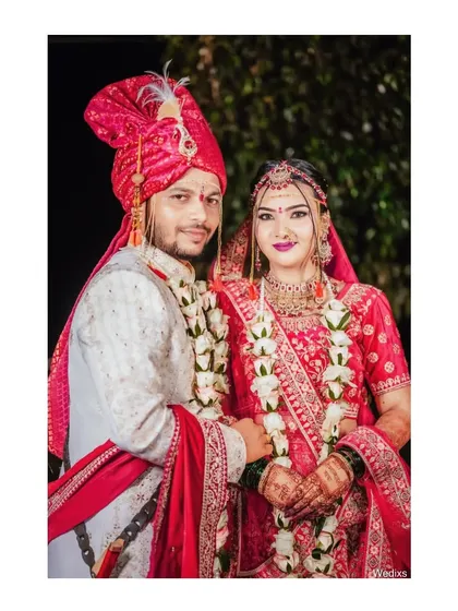 A framed portrait of a couple in their wedding attire, looking confidently towards the camera.