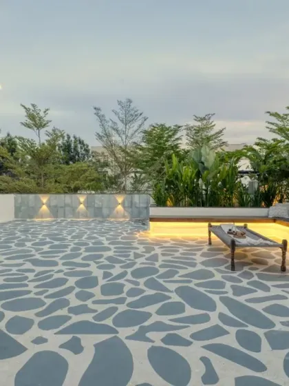 The expansive terrace at Villa 17, with its Greek-inspired Kota stone flooring, offers a serene space for outdoor living and enjoying the evening sky.