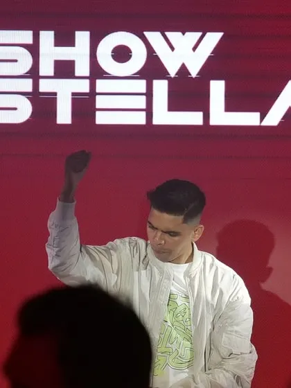 Commanding the stage at Brillo, Nagpur, with my logo displayed prominently on the massive red screen behind me.
