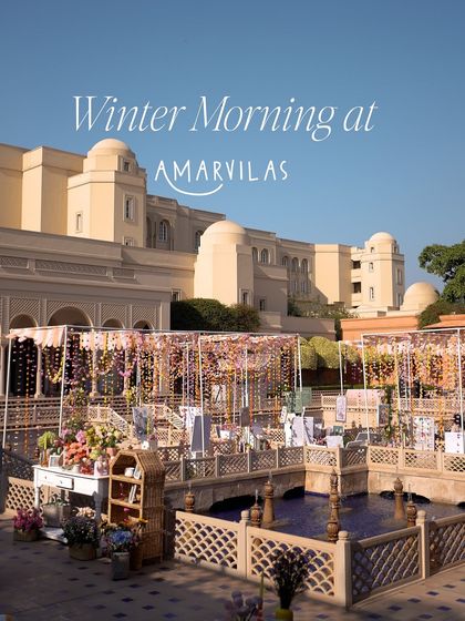 A wide shot of the "Winter Morning at Amarvilas" brunch setup. The open courtyard was transformed with floral and fabric canopies, creating a festive and whimsical atmosphere.