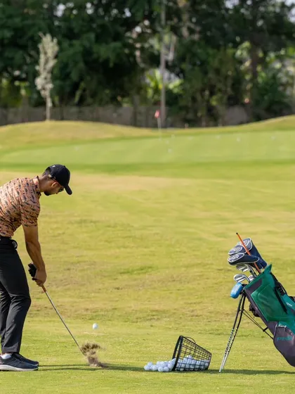 This image captures the moment of impact during a short game drill. Our practice areas allow for focused repetition to master these critical scoring shots.