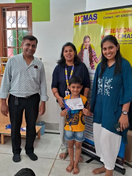 Another successful student with his proud parents and teacher. Community and support are key to our programs.