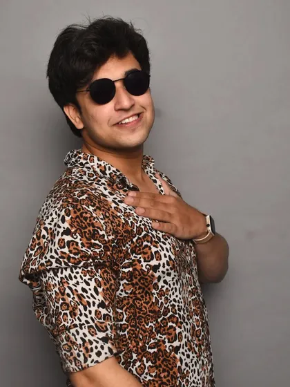 A candid-style photo from the same animal print shoot. It has a relaxed and happy vibe, showing a more approachable side to the high-fashion look.