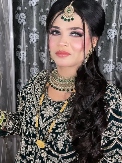 Mesmerizing beauty. Our beautiful bride is ready for her Walima in a stunning dark green outfit with dramatic eye makeup and glossy lips.