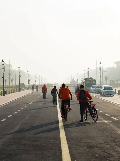 A guide walks his bike for a moment, ensuring the group is ready for the next leg of the journey. Safety and group coordination are our top priorities.